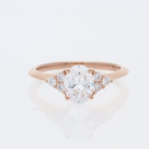 14 Karat Rose Gold Oval Center Pavé |Cluster of Three Diamonds on Each Side of Center & Cut Out Under Basket Engagement Ring